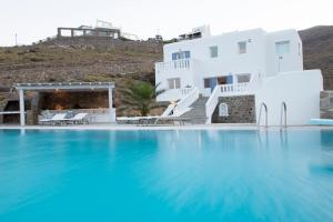 a view of a swimming pool with a house in the background at Villa Anatoli in Mýkonos City