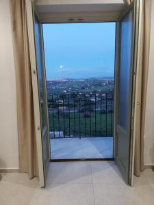 an open door to a balcony with a view at Masseria Torre Saracena in Agrigento