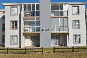 a white building with a bench in front of it at 201 Hexrivier in Hartenbos