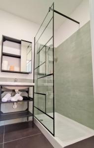 a glass shower in a bathroom with a sink at Lexie Suites in Rome