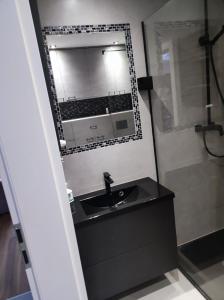 a bathroom with a sink and a mirror at Apartament Frombork in Frombork