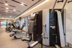 a gym with several treadmills and cardio machines at City Stay Prime Hotel Apartments - Al Barsha in Dubai