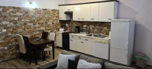 a kitchen with a table and a kitchen with white cabinets at Apartments Maletic in Pula