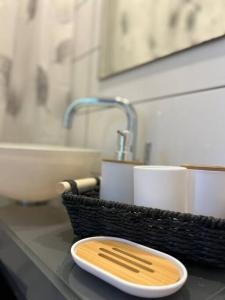 a bathroom counter with a sink and a plate on it at Central Haifa Quite Place in Haifa