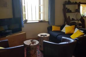 a living room with a couch and two chairs at La coume du cerf in Campan