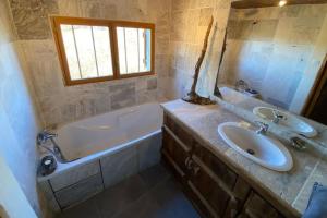 a bathroom with a sink and a bath tub and a sink at La coume du cerf in Campan +44 photos