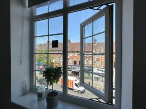 uma janela aberta com vista para uma rua da cidade em Spectacular Modern, Brand-New, 1 Bed Flat, 15 Mins Away From Central London em Hendon