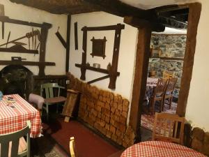 a dining room with a table and a fireplace at Etno kuca Petrovic in Štrpce