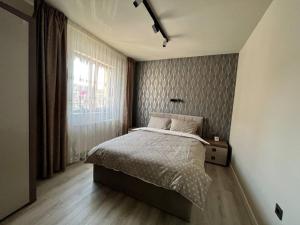 a bedroom with a large bed and a window at Sweet home in Floreşti