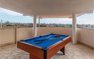 a pool table sitting on top of a balcony at Awesome Home In Valtursko Polje With Kitchen in Valtura
