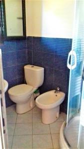 a bathroom with a toilet and a bidet at Ramo's Spectacular 2-Story Holiday Home with Radhime Views in Vlorë