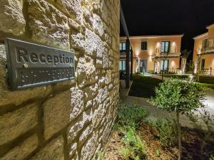 a sign on the side of a stone building at Nissos Apartments in Myrina