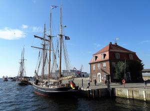 um barco ancorado na água ao lado de um edifício em Ferienhaus in der Hansestadt mit Blick auf Ostsee em Wismar