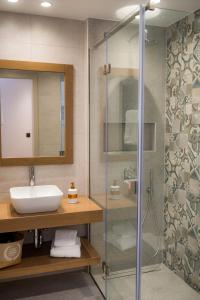 a bathroom with a sink and a shower at Nissos Apartments in Myrina