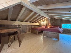 a attic room with two beds and a piano at chalet du Champel jacuzzi in Saint-Gervais-les-Bains