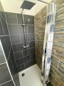 a shower with a glass door in a bathroom at Haus Ogertschnig Feichterwirth in Glanegg