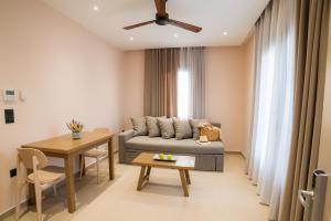 a living room with a couch and a table at Nissos Apartments in Myrina +37 photos