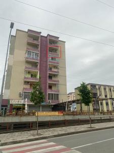 a tall building with a red stripe on the side of it at Cloud8 Apt with Castle View, 7km from the Beach in Lezhë