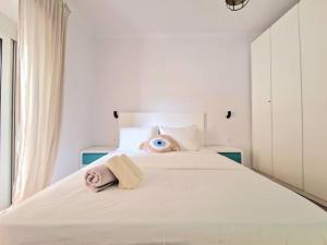 a bedroom with a bed with an eye on the pillow at Rafaela Sea Apartment in Sarandë