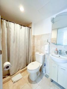 a bathroom with a toilet and a sink at Costa Linda walking distance to the beach in Jacó