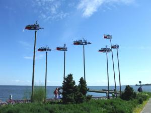 a group of poles with cars on them near the water at Jachta Varuna in Nida
