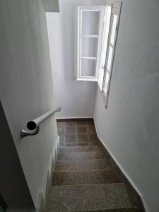 a stairway with a window and a door and a stair sidx sidx at Casa Roge in Luarca