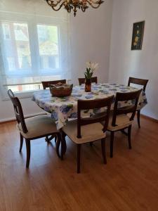 a dining room with a table and chairs with a table at Casa Roge in Luarca