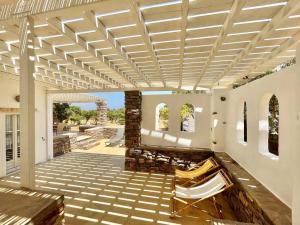 a patio with awning and a table and chairs at Villa Santa Maria-Sophia in Kampos Paros
