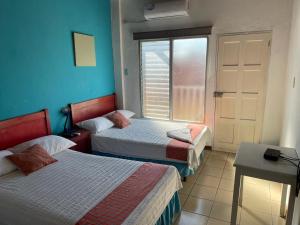 Een bed of bedden in een kamer bij Hotel Villa Margarita