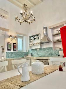 a kitchen with a chandelier and a white counter top at Villa Santa Maria-Sophia in Kampos Paros