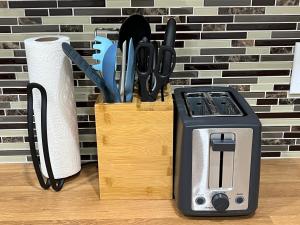 a knife block with a toaster and a roll of paper towels at Trendy in Tremont, Cleveland (Upper) in Cleveland