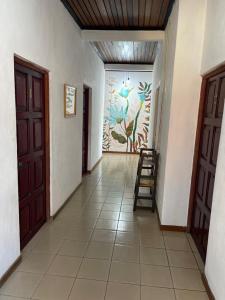a hallway with two doors and a painting on the wall at Hotel Villa Margarita in Flores