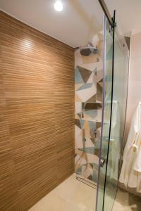a bathroom with a shower with a glass door at Nissos Apartments in Myrina