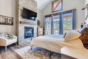 a bedroom with a bed and a fireplace at Seasons 1825 in Keystone