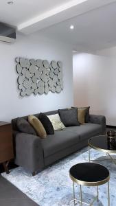 a living room with a couch and a table at Nuben Court- Kumasi City in Kumasi