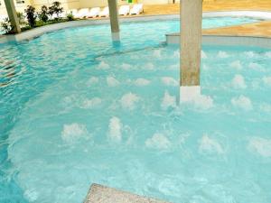 a swimming pool with clouds in the water at Exclusive Residence Thermas Diroma in Caldas Novas