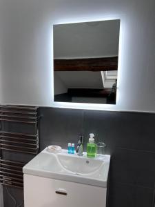 a bathroom with a white sink and a mirror at Skyline Silence Suite in Milan