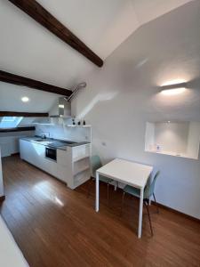 a kitchen and dining room with a table and chairs at Skyline Silence Suite in Milan