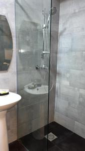 a bathroom with a shower and a sink at Nuben Court- Kumasi City in Kumasi
