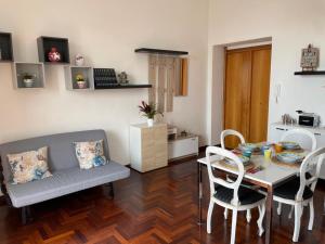 a living room with a table and a table and chairs at Casa Giulia in Vietri sul Mare