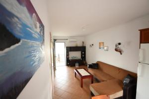 a living room with a couch and a refrigerator at South Side in Athani