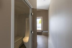 a bathroom with a shower and a toilet and a mirror at Villa Misano in Le Mans