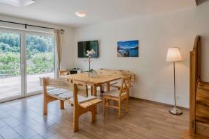 - une salle à manger avec une table et des chaises en bois dans l'établissement 2Geräumiges Ferienhaus in den schönen Alpen, à Döbriach