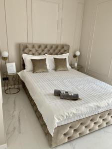 a bedroom with a large bed with a large headboard at Mali by the Lake - North Mamaia in Mamaia