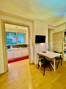 a room with a table and a kitchen with a window at Auditorium luxury suite Roma in Rome