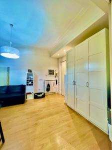 a living room with a couch and a large white closet at Auditorium luxury suite Roma in Rome