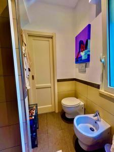 a bathroom with a white toilet and a sink at Auditorium luxury suite Roma in Rome