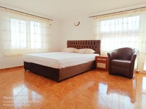 1 dormitorio con 1 cama y 1 silla en Moni 85 Family House, en Sozopol