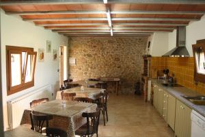 a restaurant with tables and chairs in a room at Masía Rural Can Poch in Pals