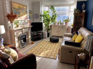 a living room with a couch and a fireplace at Gateway to the South Downs Near Brighton in Portslade